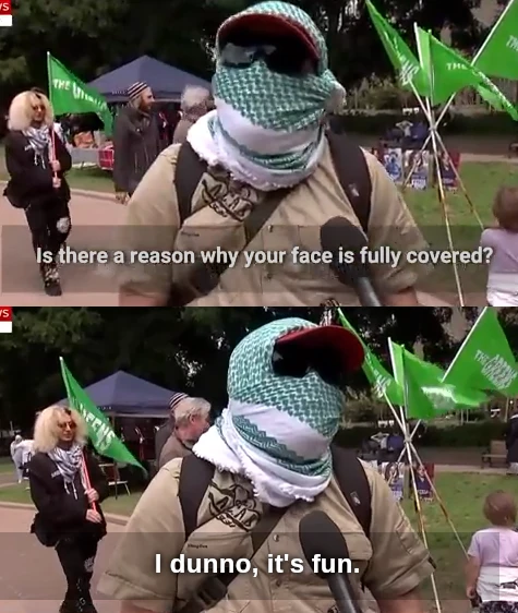 An interviewer asks a protestor with sunglasses and a fully-wrapped face: "Is there a reason why your face if fully covered?". The protester simply replies: "I dunno, it's fun."