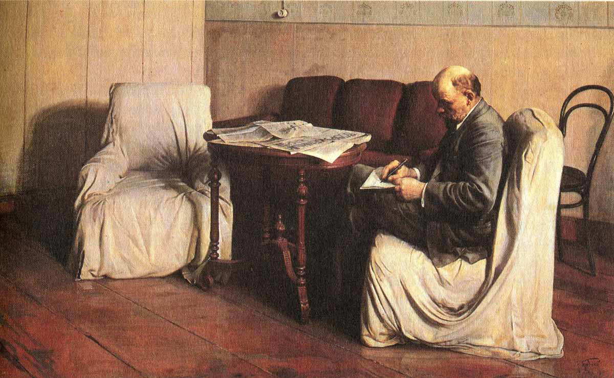 A picture of Lenin, sitting down on a chair, writing on paper